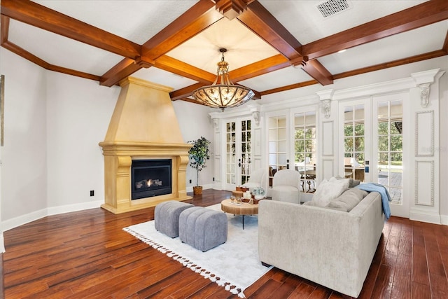 living room featuring a large fireplace, dark hardwood / wood-style floors, french doors, and beamed ceiling