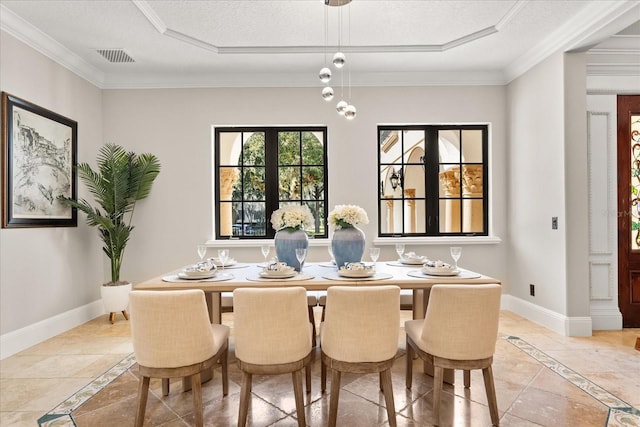 dining room featuring crown molding, a raised ceiling, and a textured ceiling