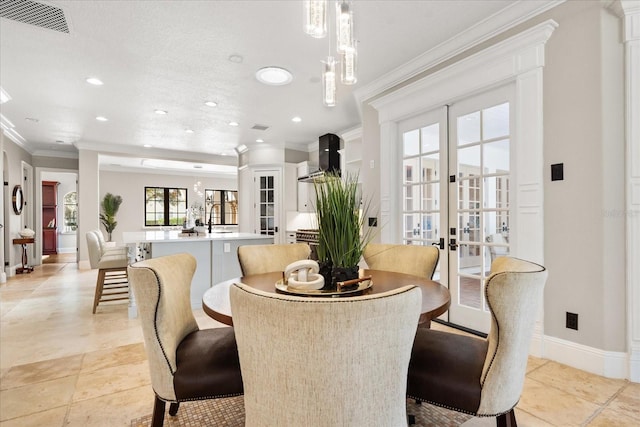 dining room featuring light tile patterned floors, ornamental molding, and french doors