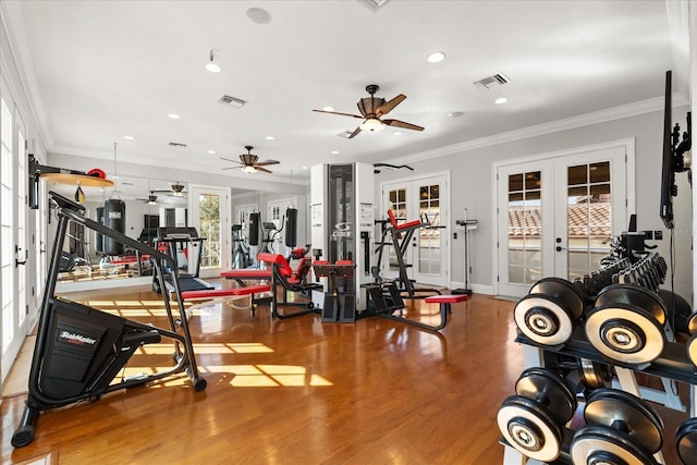 gym with hardwood / wood-style flooring, ornamental molding, and french doors