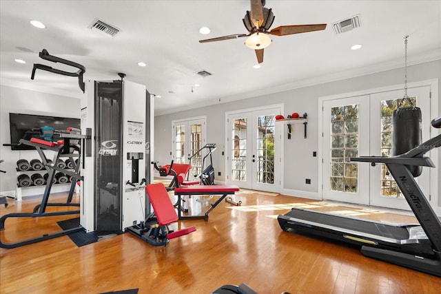 exercise room with hardwood / wood-style flooring, crown molding, ceiling fan, and french doors