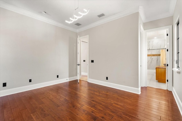 unfurnished room featuring hardwood / wood-style floors and ornamental molding