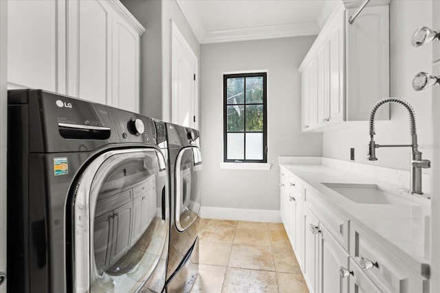 laundry area featuring cabinets, washing machine and dryer, sink, and crown molding