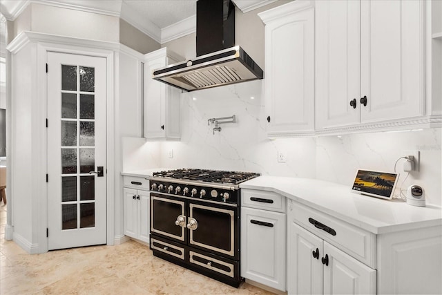 kitchen featuring white cabinetry, backsplash, ornamental molding, custom range hood, and range with two ovens