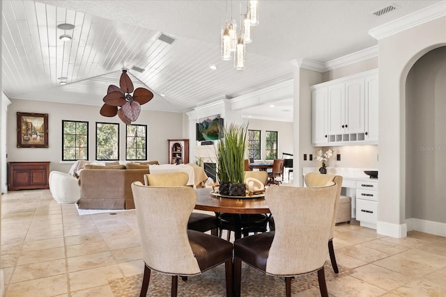 dining space with wood ceiling, ornamental molding, and vaulted ceiling