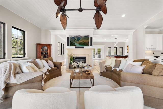 living room featuring lofted ceiling, wood ceiling, ceiling fan, ornamental molding, and light tile patterned flooring