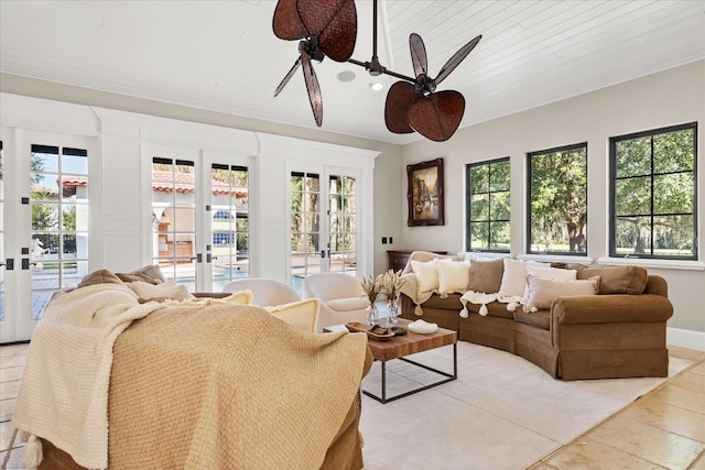 living room featuring ceiling fan and french doors