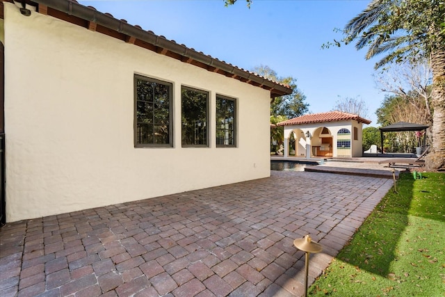 view of patio / terrace with an outbuilding