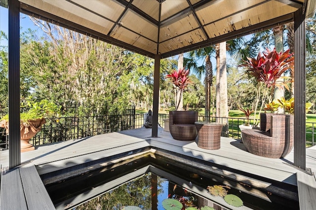 wooden terrace featuring a gazebo