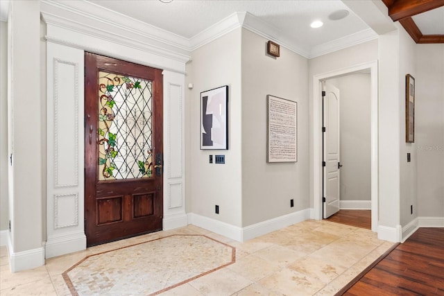 entryway with crown molding and light hardwood / wood-style floors