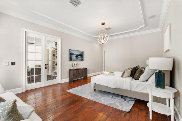 bedroom with ornamental molding, a chandelier, and dark hardwood / wood-style flooring