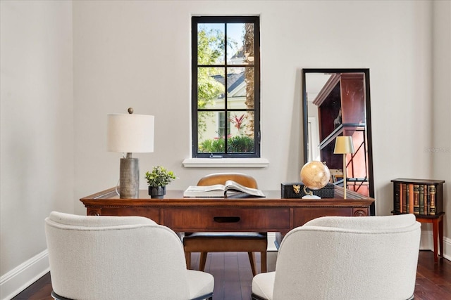 office space featuring a wealth of natural light and dark hardwood / wood-style floors