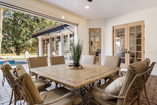 dining room featuring wooden ceiling and french doors