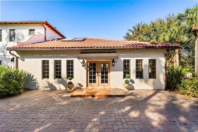 back of property with a patio area and french doors