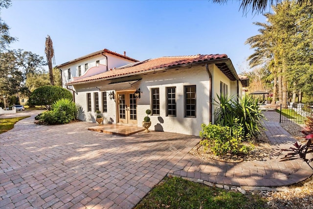 back of house with a patio area and french doors