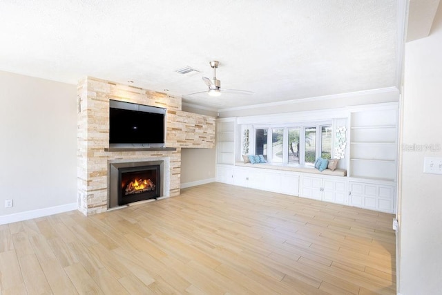 unfurnished living room with a fireplace, light hardwood / wood-style flooring, and ceiling fan