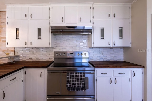 kitchen featuring range with two ovens, white cabinets, and backsplash