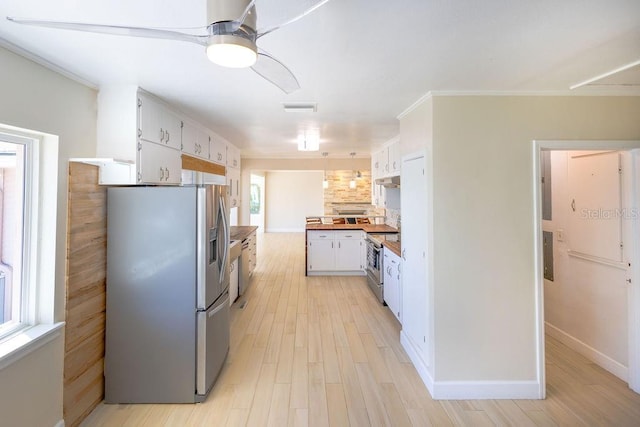 kitchen with crown molding, wooden counters, stainless steel appliances, white cabinets, and light wood-type flooring