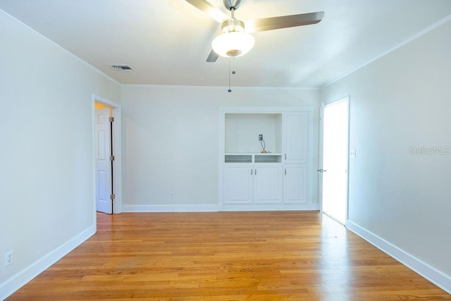 empty room with crown molding, ceiling fan, and light wood-type flooring