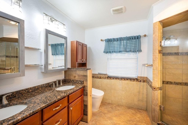 bathroom featuring tile walls, vanity, ornamental molding, an enclosed shower, and toilet