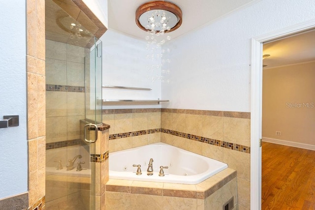 bathroom featuring hardwood / wood-style flooring and shower with separate bathtub