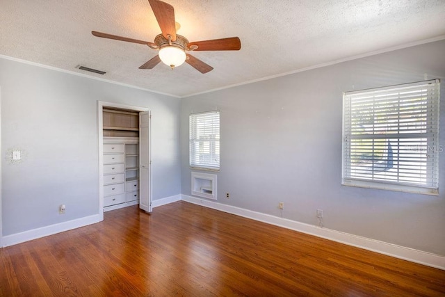 unfurnished bedroom featuring crown molding, hardwood / wood-style floors, and a textured ceiling