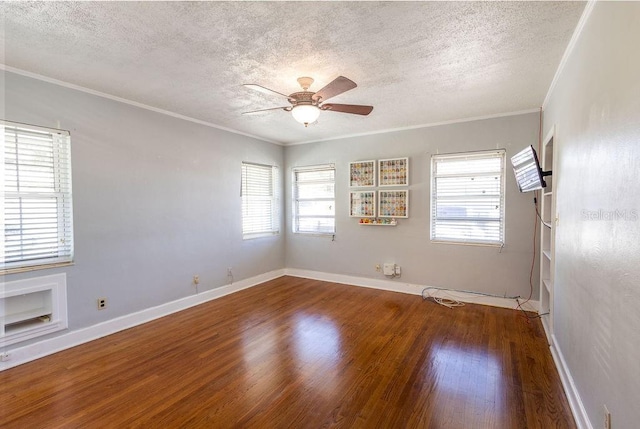 empty room featuring crown molding, ceiling fan, hardwood / wood-style floors, and a textured ceiling