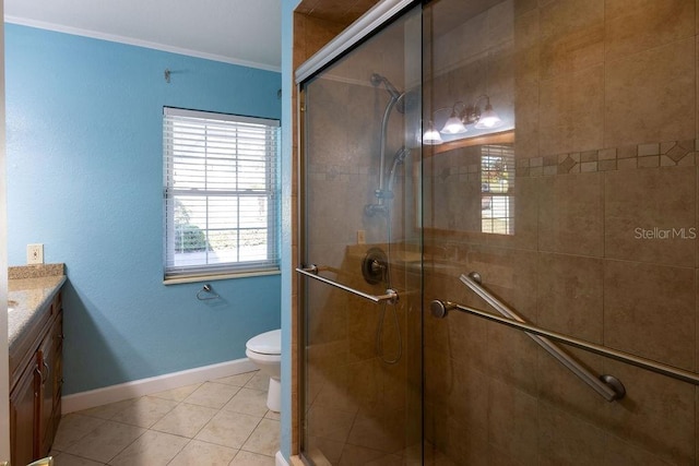 bathroom featuring vanity, walk in shower, toilet, crown molding, and tile patterned floors