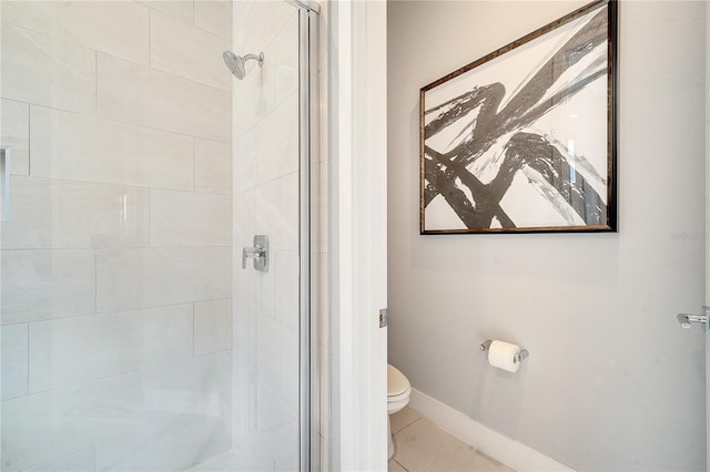 bathroom featuring a shower with door, tile patterned floors, and toilet