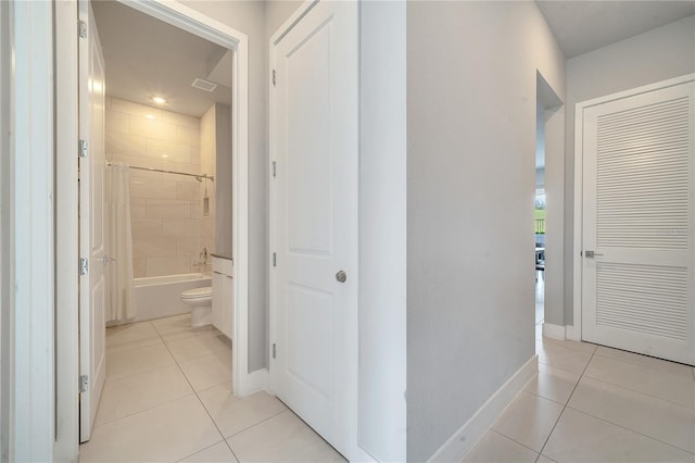 corridor featuring light tile patterned floors