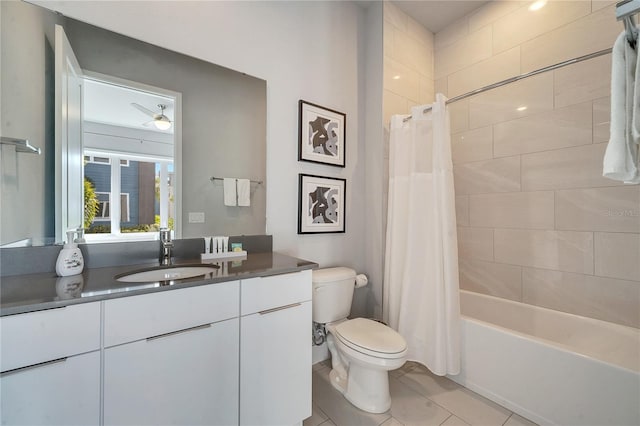 full bathroom featuring shower / tub combo with curtain, tile patterned flooring, vanity, ceiling fan, and toilet