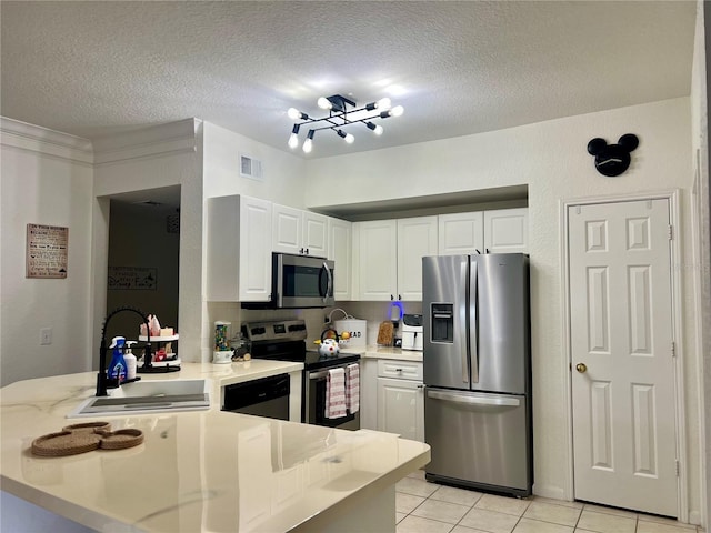 kitchen featuring sink, white cabinetry, light tile patterned floors, appliances with stainless steel finishes, and kitchen peninsula