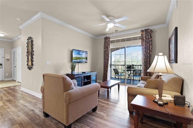 living room featuring hardwood / wood-style flooring, ceiling fan, and ornamental molding