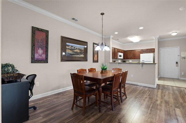 dining room featuring crown molding and dark hardwood / wood-style flooring