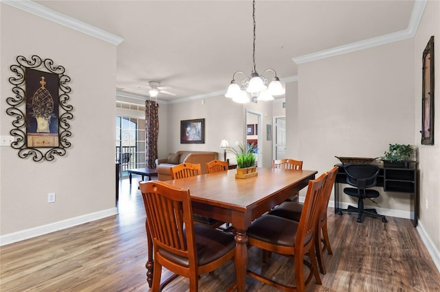 dining area with hardwood / wood-style floors, crown molding, and ceiling fan with notable chandelier