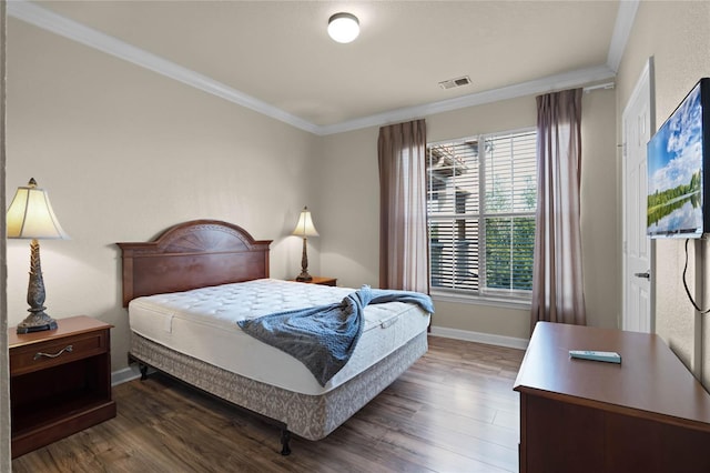 bedroom featuring crown molding and dark hardwood / wood-style flooring