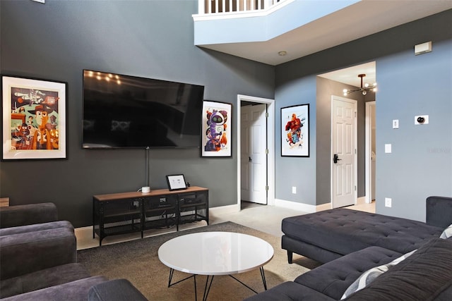 carpeted living room featuring a chandelier