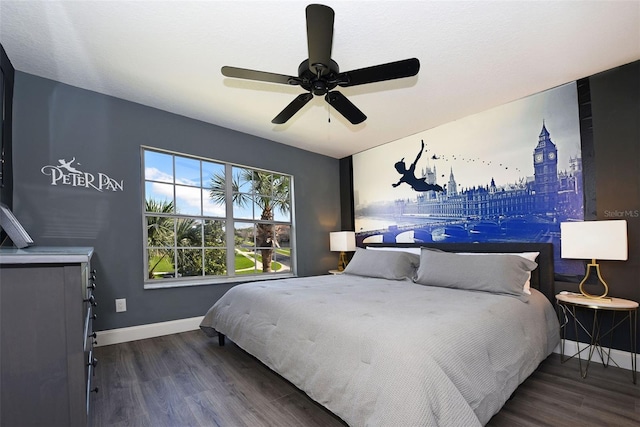 bedroom with dark hardwood / wood-style flooring and ceiling fan