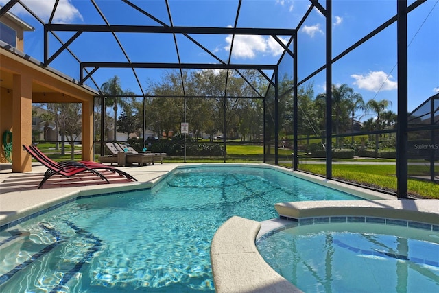 view of pool featuring an in ground hot tub, a patio, and glass enclosure