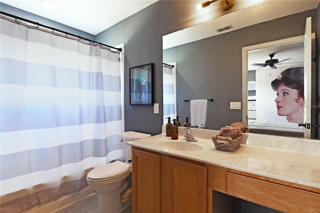 bathroom featuring ceiling fan, vanity, toilet, and tile patterned floors