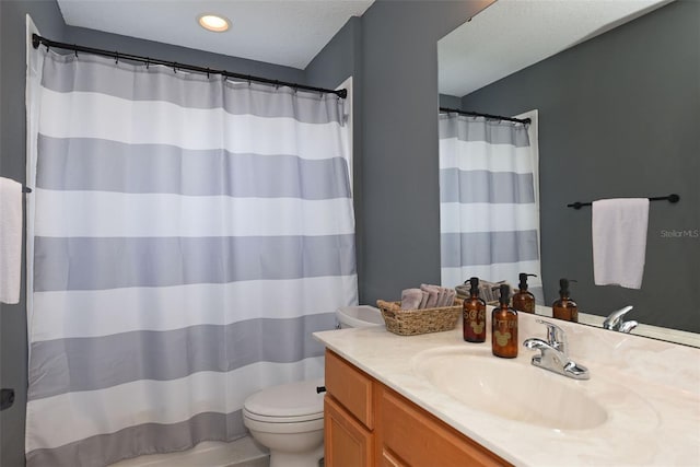 bathroom with vanity, a textured ceiling, and toilet