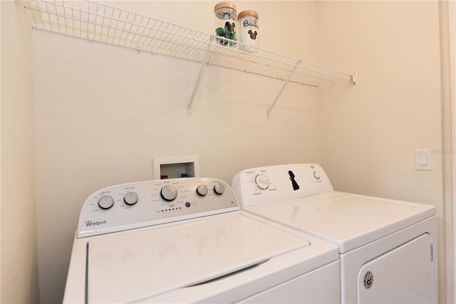 clothes washing area featuring separate washer and dryer