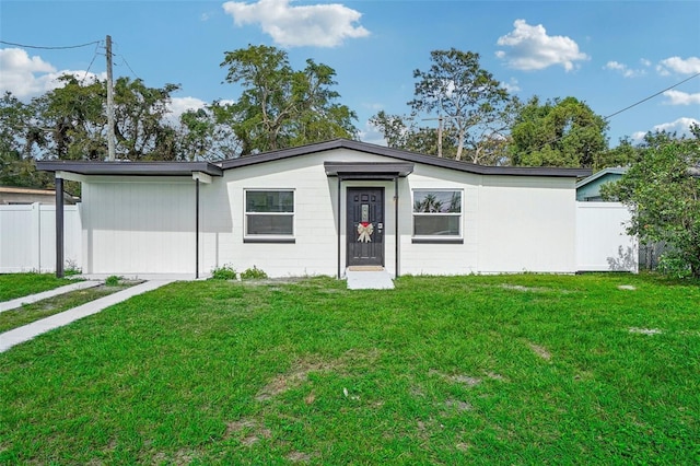 ranch-style home with a front lawn