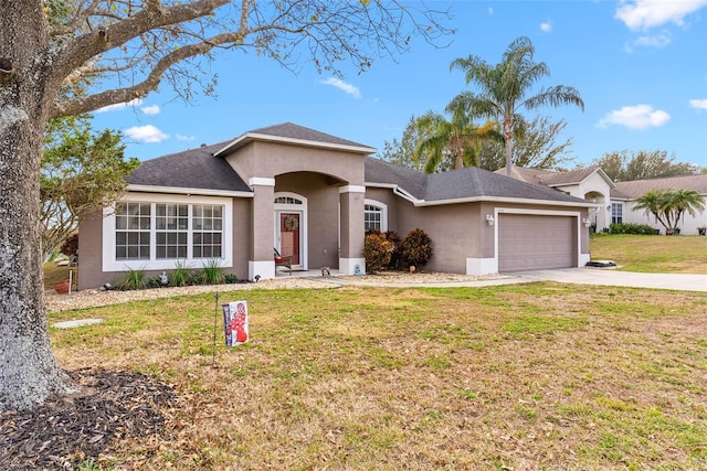 ranch-style house with a garage and a front lawn