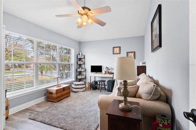 living room with ceiling fan and light wood-type flooring