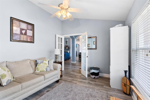 living room featuring vaulted ceiling, wood-type flooring, ceiling fan, and french doors