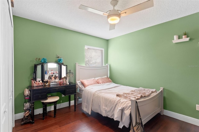 bedroom featuring dark wood-type flooring and a textured ceiling