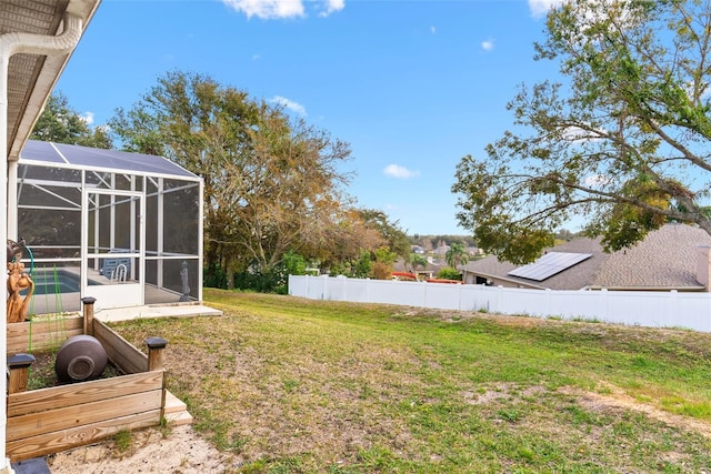 view of yard with glass enclosure