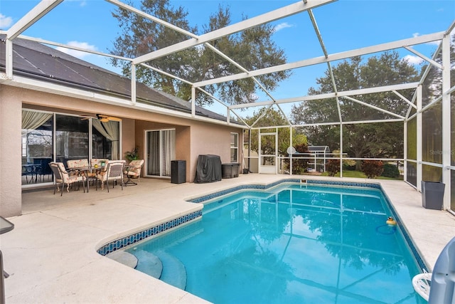 view of pool featuring a patio area and glass enclosure