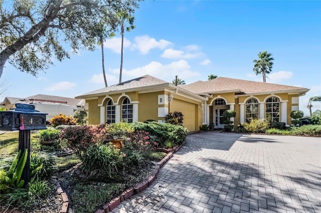 mediterranean / spanish house featuring a garage